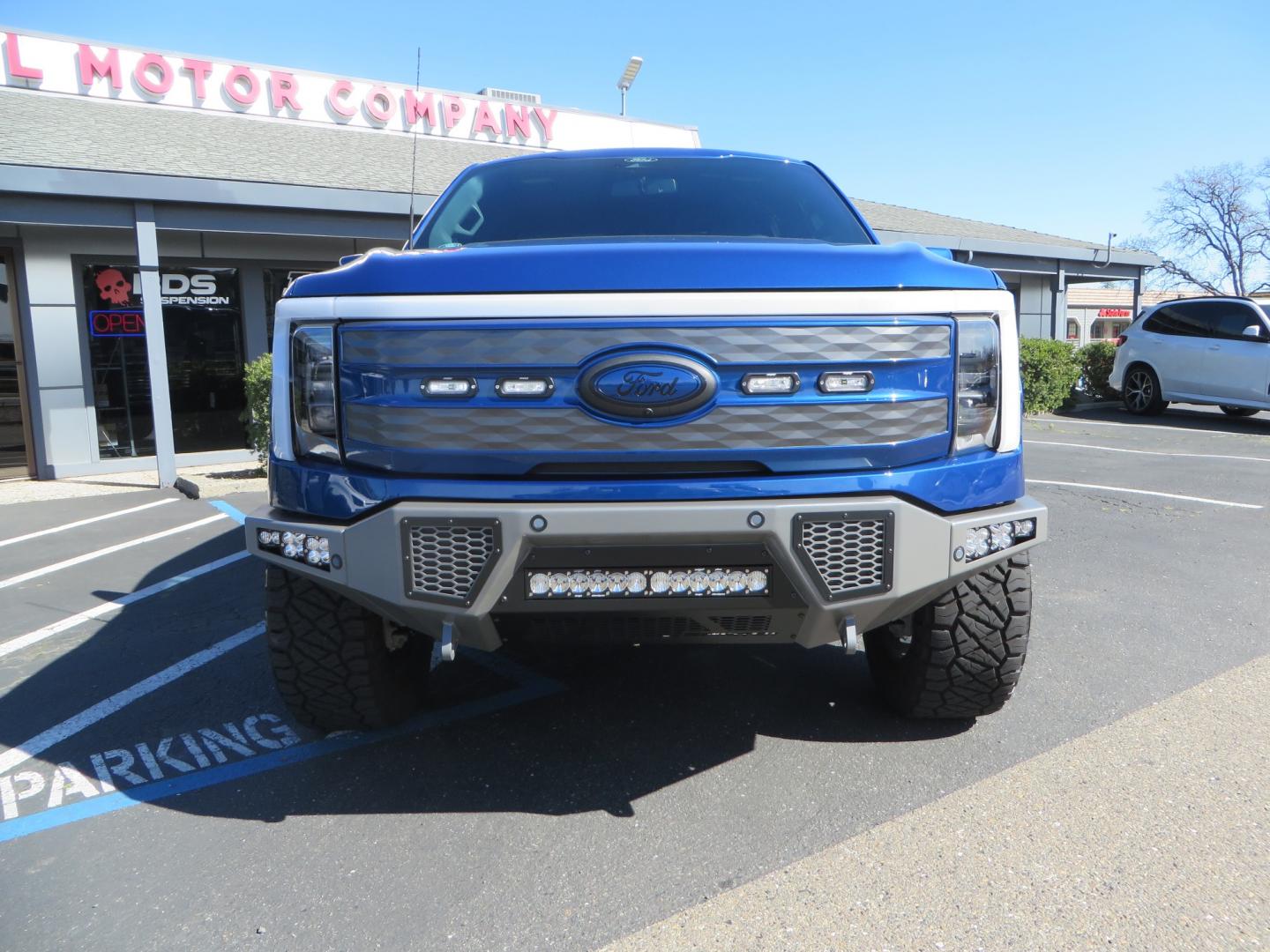 2022 BLUE /BLACK Ford F-150 Lariat Crew Cab 4WD (1FT6W1EV6NW) , located at 2630 Grass Valley Highway, Auburn, CA, 95603, (530) 508-5100, 38.937893, -121.095482 - Tired of gas prices and still want to look cool? Check out this Ford Lightning featuring a RC level kit, Nitto Ridge Grappler tires, Fuel Rebel wheels, Sinister front and rear bumpers, Baja Designs leds, Rigid Industries Leds, Bakflip F1, and window tint. - Photo#1